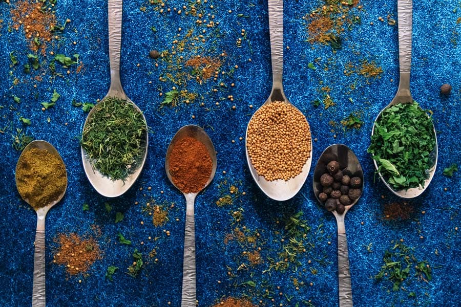 A variety of herbs and spice on spoons