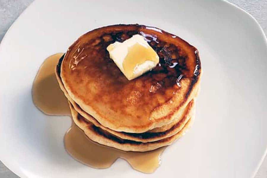 stack of sourdough pancakes on a white plate